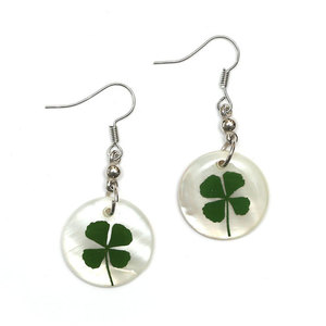 Green four-leaf clover set in white round shell disc dangle earrings